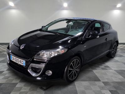 the black car is parked on a checkered floor in the garage