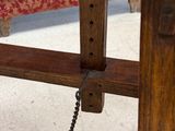 a close up of a wooden table with a chain on it
