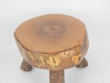 a small wooden stool that has a tree stump on it