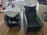 two chairs that are sitting next to each other in a room