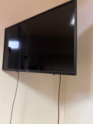 a flat screen tv hanging on the wall in the room
