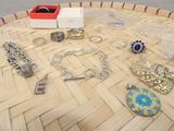 a lot of jewelry sitting on a table on the floor