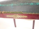 a close up of a bench with a green and red seat