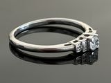 a close up of a diamond ring on a table