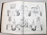 an open book with a drawing of a building and a statue