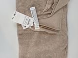 the blanket has a tag on it on a white surface