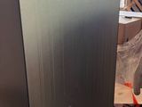 a refrigerator that is sitting on a pallet in a warehouse