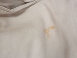 a close up of a person ' s shirt with a cross on it