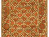 an orange and green rug with a floral design on it