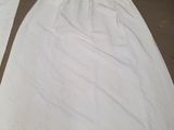 two pieces of white cloth are laying on the floor next to each other