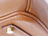 a close up of a brown purse with a zipper