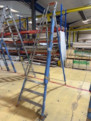 many ladders that are sitting in a warehouse