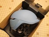 a helmet that is in a box on the floor