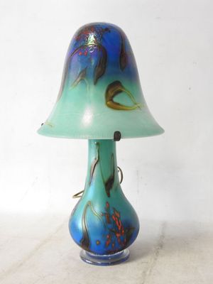 a blue and green lamp that is sitting on a table