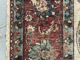 a close up of a red and blue rug on a blue floor