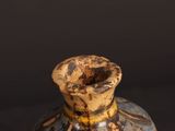 a vase that has a brown and blue design on it
