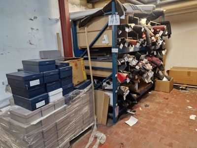 many boxes and boxes stacked on a rack in a room
