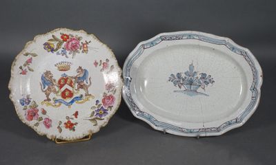 two plates with designs on them sitting side by side on a table