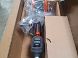 a box with a remote control and a tool in it