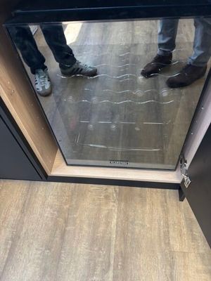 someone standing in front of a glass door with their feet on the floor