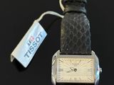 an image of a close up of a wrist watch with a tag attached to it