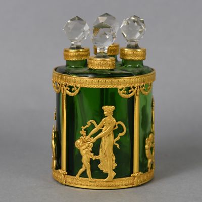 a green glass box with a gold decoration on it