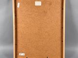 a wooden box with a cork board inside and a label on it