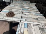 the table is made out of wood planks and has a piece of wood on it