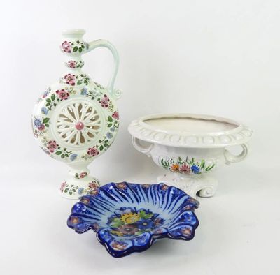two vases and a bowl on a white table