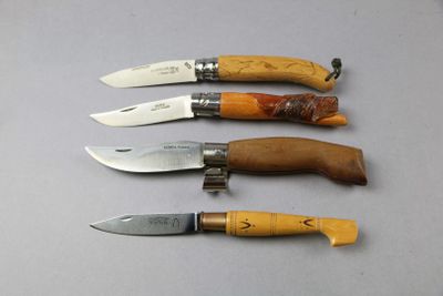 several knives are lined up in a row on a table