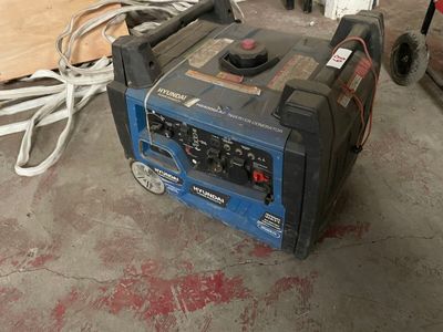 a blue and black generator sitting in a garage