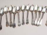 six spoons are lined up in a row on a table
