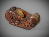 an old wooden plane with a carved inscription on it