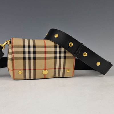 the small vintage check and leather belt bag is on display
