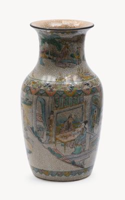 a vase with a painting on it sitting on a table
