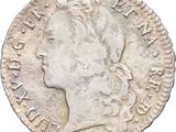 a close up of a coin with a woman ' s head on it