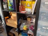 a black bookcase filled with lots of different items