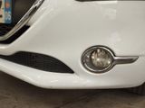 a close up of a white car with a license plate on it