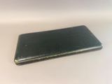 a small black cell phone sitting on a table