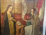 painting of a woman reading a book with an angel in the background