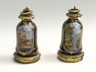 two vases with paintings on them sitting on a white surface