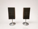pair of speakers on metal stands against a white background