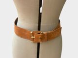 ceinture en cuir marron sur un torse de mannequin, avec une boucle noire et dorée