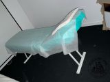 a bed with a blue sheet on it in a room