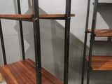 the shelves are made of wood and metal, with a wooden shelf underneath them