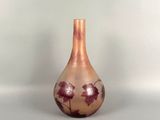 a small vase with a floral design on it