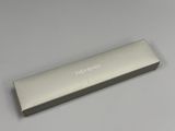 an image of a silver pencil case on a table