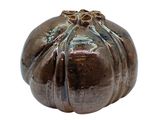 a brown vase that is sitting on a white surface