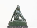 statue of a woman sitting on a marble base