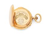 an image of a close up of a pocket watch on a white surface